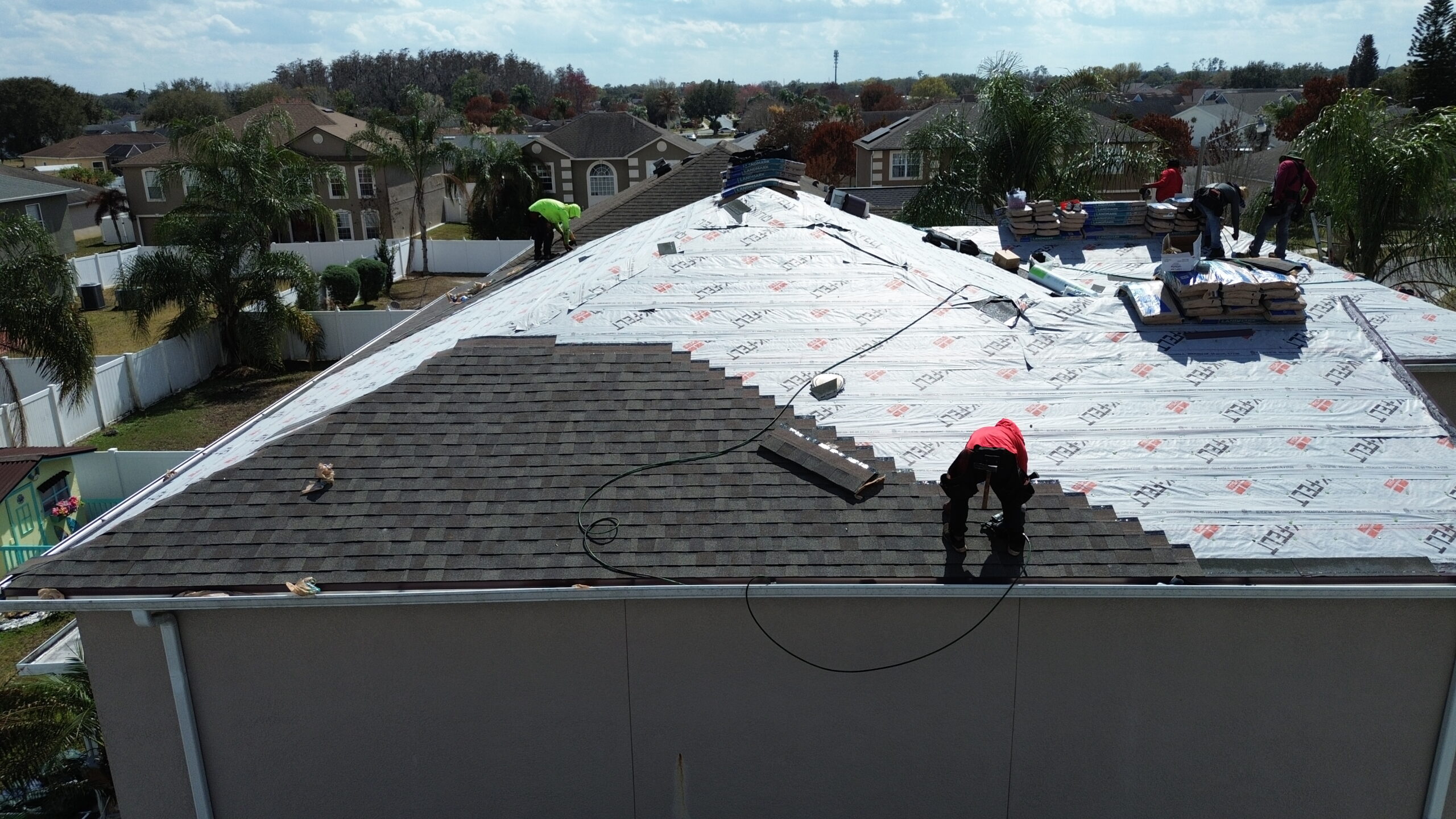 Certified roofing contractor in Orlando installing premium asphalt shingles.